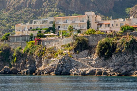 A waterfront building with terraces overlooking the sea